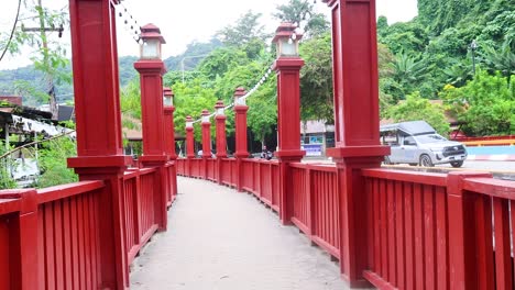 red wooden bridge with walking path