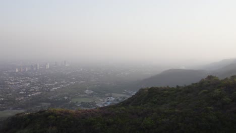 evening aerial view of islamabad with city skyline, faisal mosque, and margalla hills. islamabad, pakistan