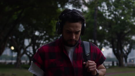 man walking in park with headphones