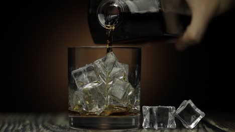 pouring whiskey on the rocks