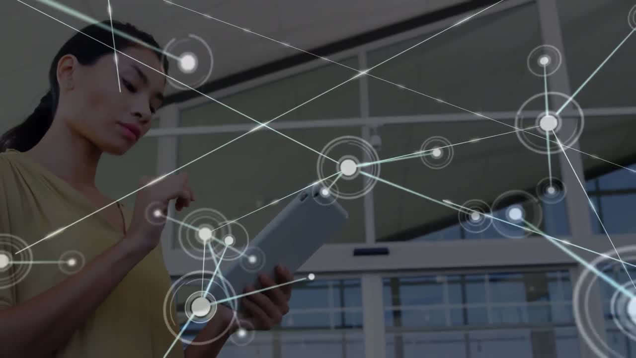 animación de una red de conexiones con iconos sobre una mujer de negocios biracial usando una tableta