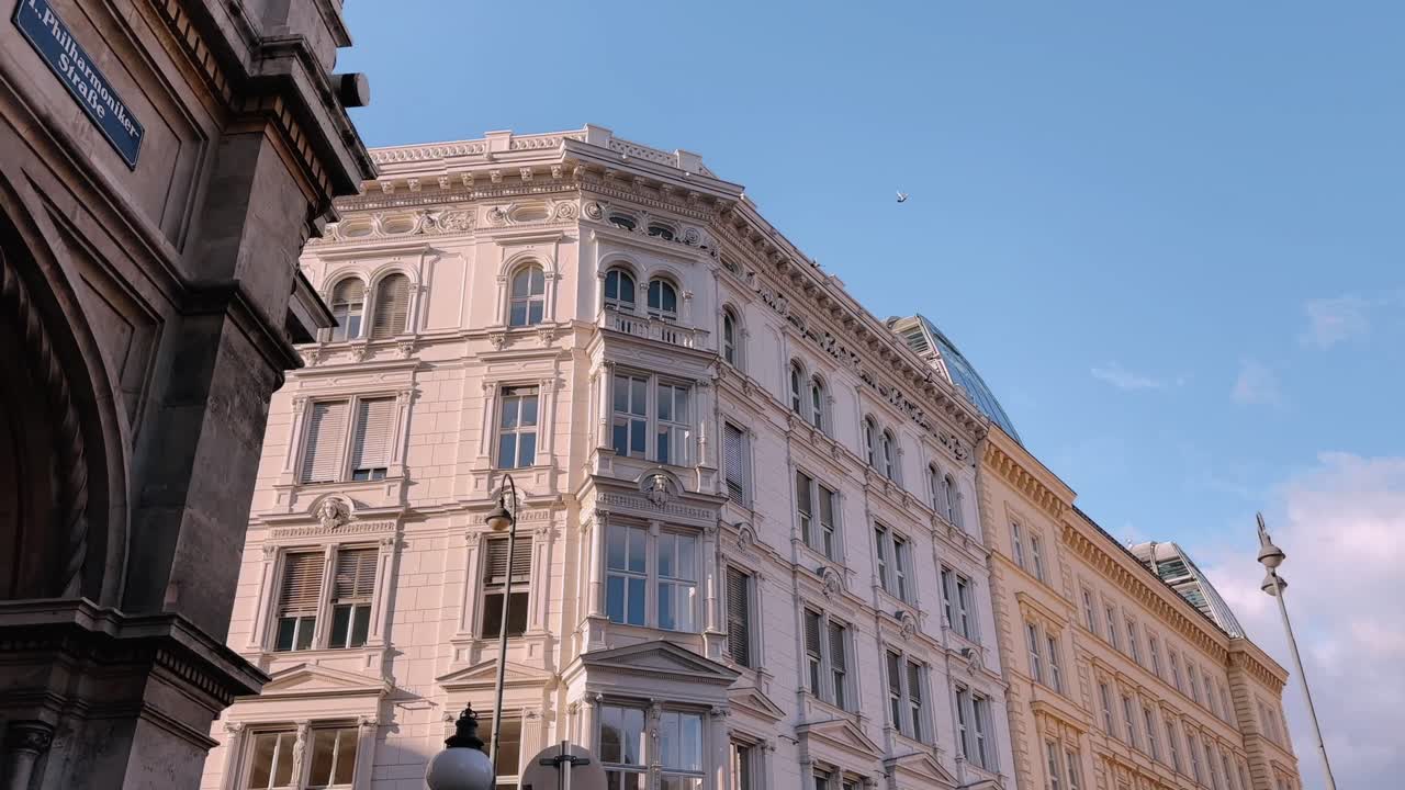 Classic European buildings with ornate facades under a blue sky in Vienna, Austria