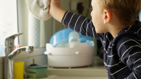 Father-and-siblings-cleaning-kitchen-sink-4k