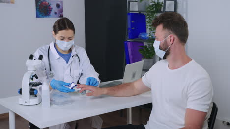 doctor performing blood glucose test on patient