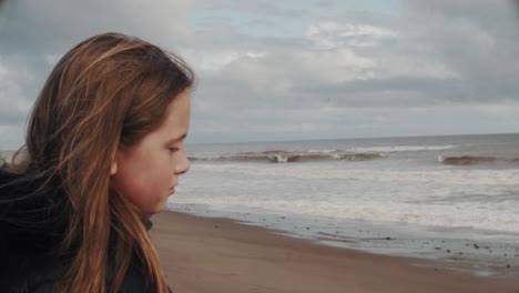 sad lonely girl looks out to sea depressed