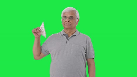 Confident-Indian-old-man-using-money-as-fan-Green-screen