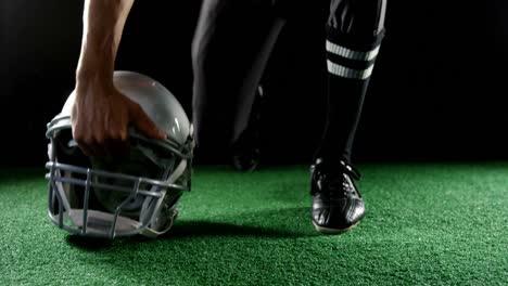 American-football-player-resting-his-hands-on-head-gear-4k