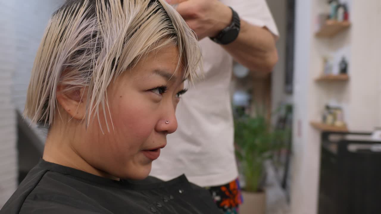 Woman getting a haircut at a salon