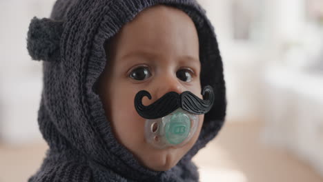 funny baby wearing moustache pacifier happy toddler sucking on dummy 4k