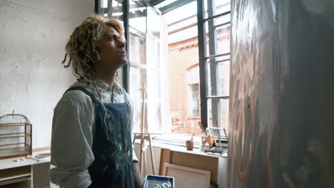 artist sitting in front of painting