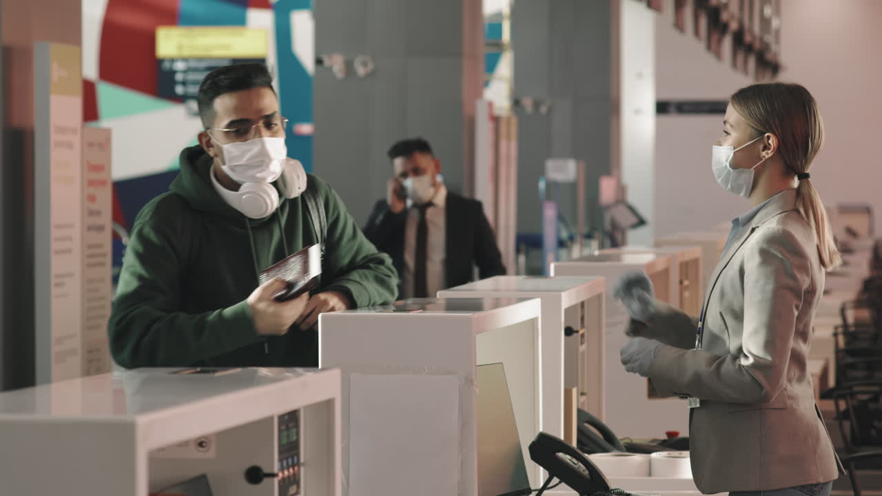 Man With Backpack At Check-In Desk