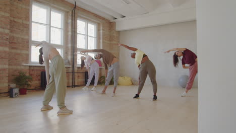 young people stretching before dance class