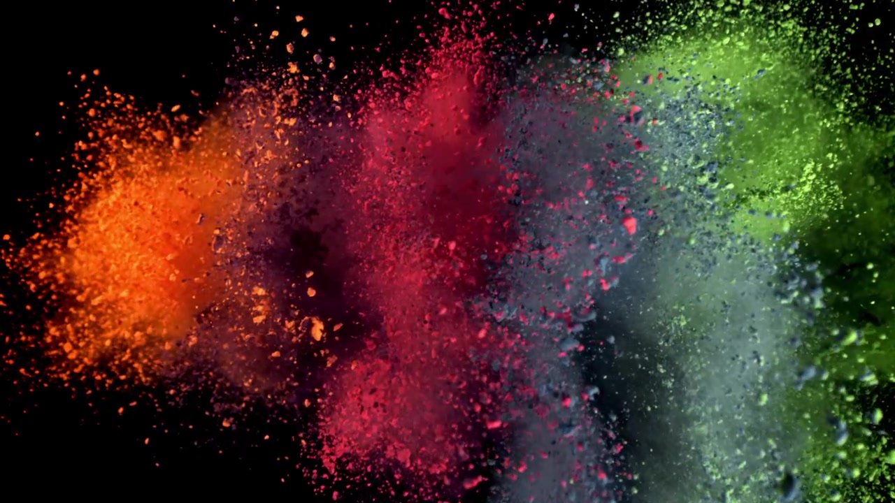 Explosión de polvo multicolor brillante en cámara lenta