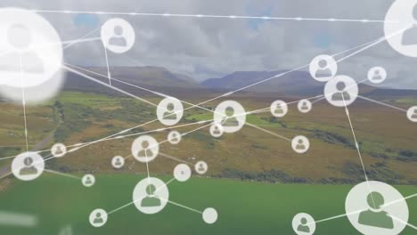 animation of network of profile icons agains aerial view of grassland