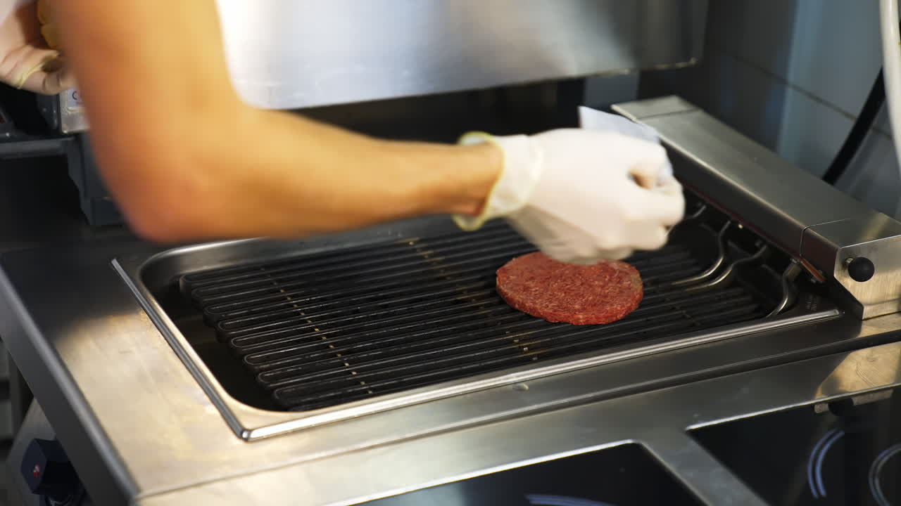 Meat roasted at restaurant kitchen. Chef cooking fresh meat cutlets on grill