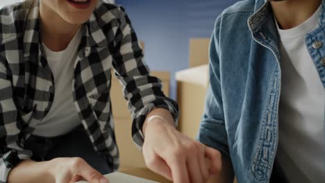 Tilt-up-video-of-couple-installing-bookshelf-together.