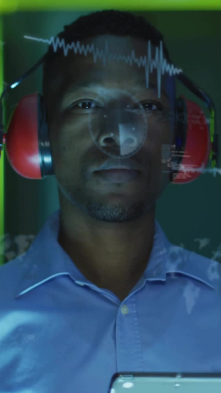 Vertical video: Tech holding tablet starting waveform layering code and map across face for testing