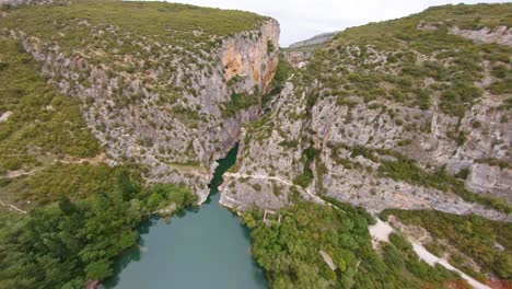 fpv aerial flying fast through a scenic mountain canyon in spain