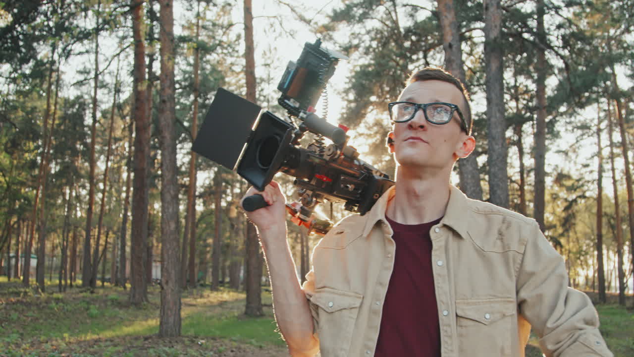 Operator With Video Camera Walking In Forest