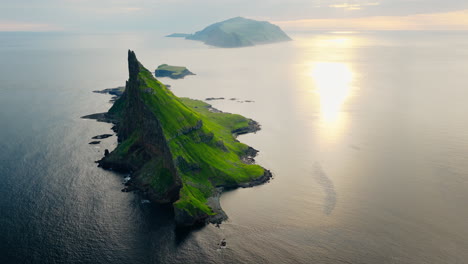 dramatic tindhólmur island in the faroe islands at sunset
