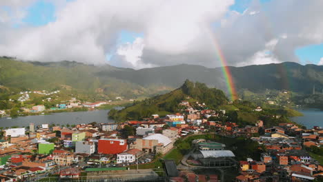 Aerial-view-of-Colombian-town-"Guatapé"-and-beautiful-rainbow