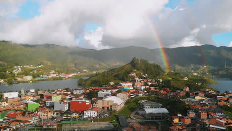 aerial view of colombian town "guatapé" and beautiful rainbow