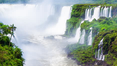 Timelapse-of-Waterfalls-of-Iguazu-around-a-big-green-area-and-a-river,-in-a-sunny-day,-Foz-do-Iguacu,-Parana,-Brazil