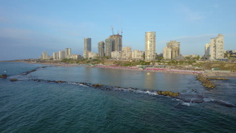 the famous bat yam rock beach - the lagoon is formed by wave breakers and most of its visitors are families with children because of the shallow water and the lack of waves