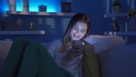 Young-woman-in-love-texting-on-the-phone-at-home-at-night.