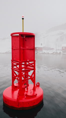 red buoy in foggy water