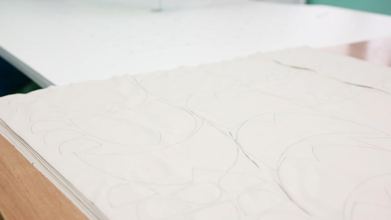 Stacked Pattern Sheets On Table Showing Pencil Outlines And Layout Marks, Soft Daylight On Clean Workspace . Media