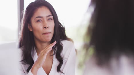 Professional-businesswoman-talking-to-her-colleagues-while-sitting-in-modern-office-in-slow-motion