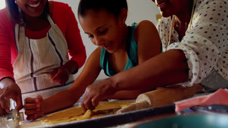 Happy-multi-generation-family-preparing-cookies-in-kitchen-4k