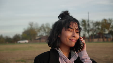 Asian-woman-listening-on-her-mobile-cellphone-and-nodding