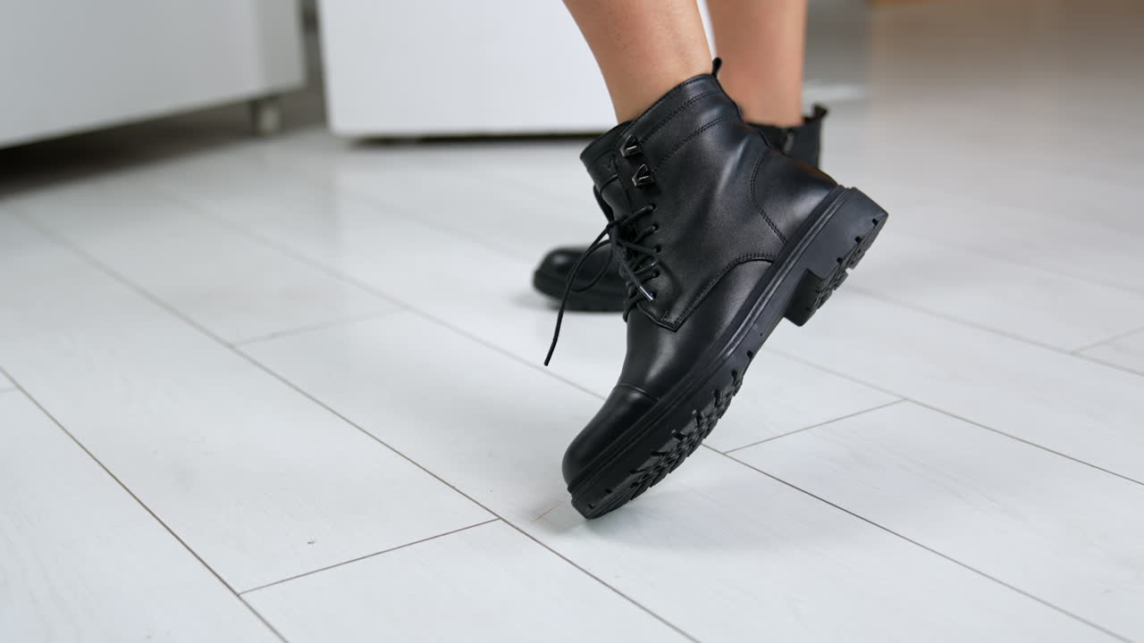 Black Leather Ankle Boots on Wooden Floor