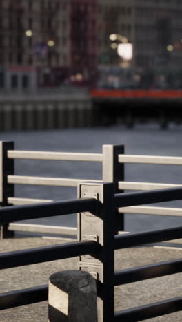 a black metal fence along the edge of a river in a city