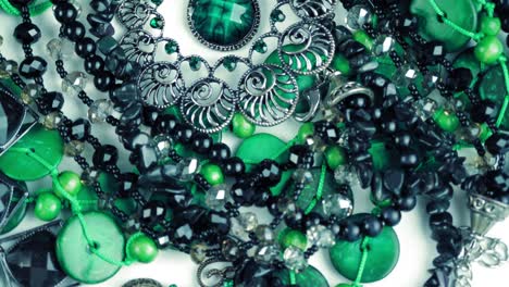 jewelry, beads. close-up. rotation. beautiful shiny, sparkling jewelry with glare in gems. macro. a lot of beads in different colors. various jewelry, stone products, green malachite beads