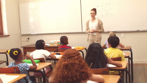 Cute-pupils-listening-to-their-teacher-in-classroom