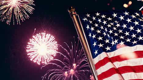 Low-angle shot of a waving American flag with vibrant fireworks in the background