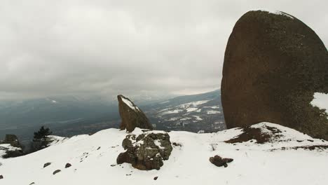 snowy mountain peaks with large rocks