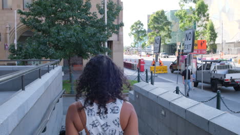woman walking wearing mask during covid19 melbourne flinders st