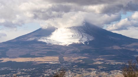 Slow-tilt-up-over-wide-view-of-Mount-Fuji-with-moving-clouds---Timelapse