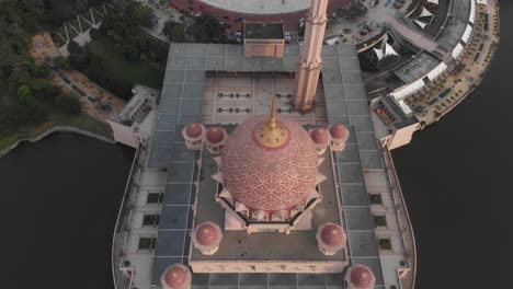 Top-down-shot-of-big-pink-Putra-mosque-at-Kuala-lumpur,-aerial