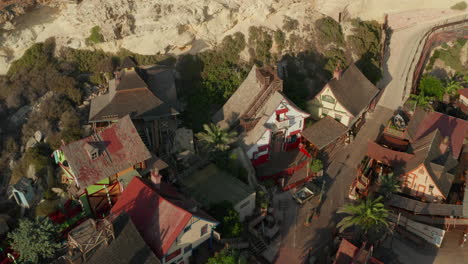 Small,-Nice-looking-Wooden-Houses-in-little-fishing-Village-on-Island-in-Sunset-light,-Aerial-Drone-perspective