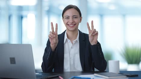 Happy-Indian-business-woman-showing-victory-sign