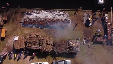 vista aérea de personas cocinando al aire libre y paletas de madera