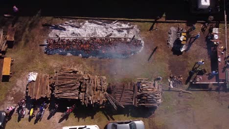 aerial view of people cooking outdoors and wood pallets