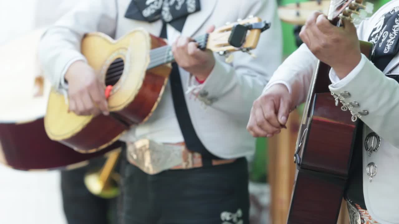 Three mexican mariachi musitian playin g the guitar, Vihuela and acoustic bass