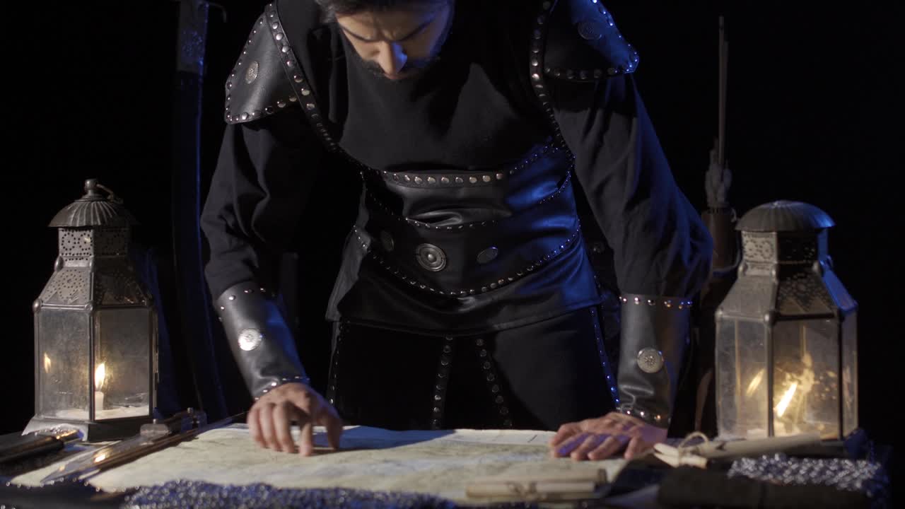 The commander who puts his hands on the table and makes a mark on the map.