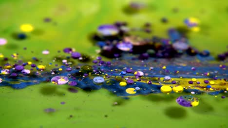 abstract colorful acrylic and food paint bubbles on water